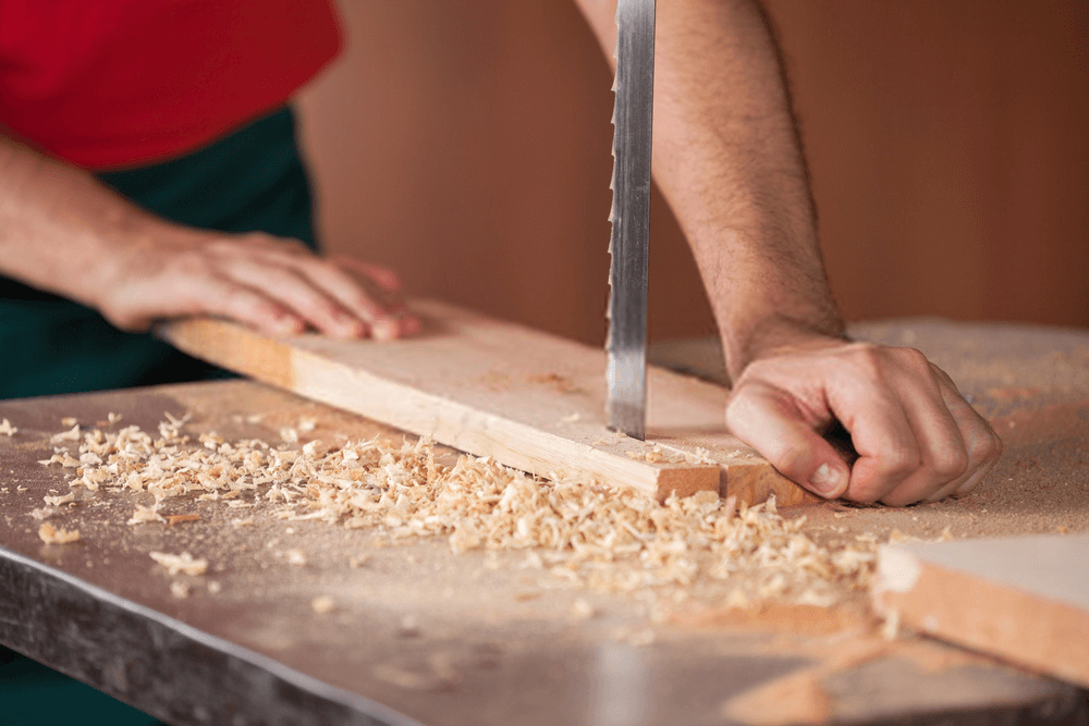 Carpenter's Hands Cutting Wood With Best Bandsaw Carpenter's Hands Cutting Wood With Best Bandsaw
