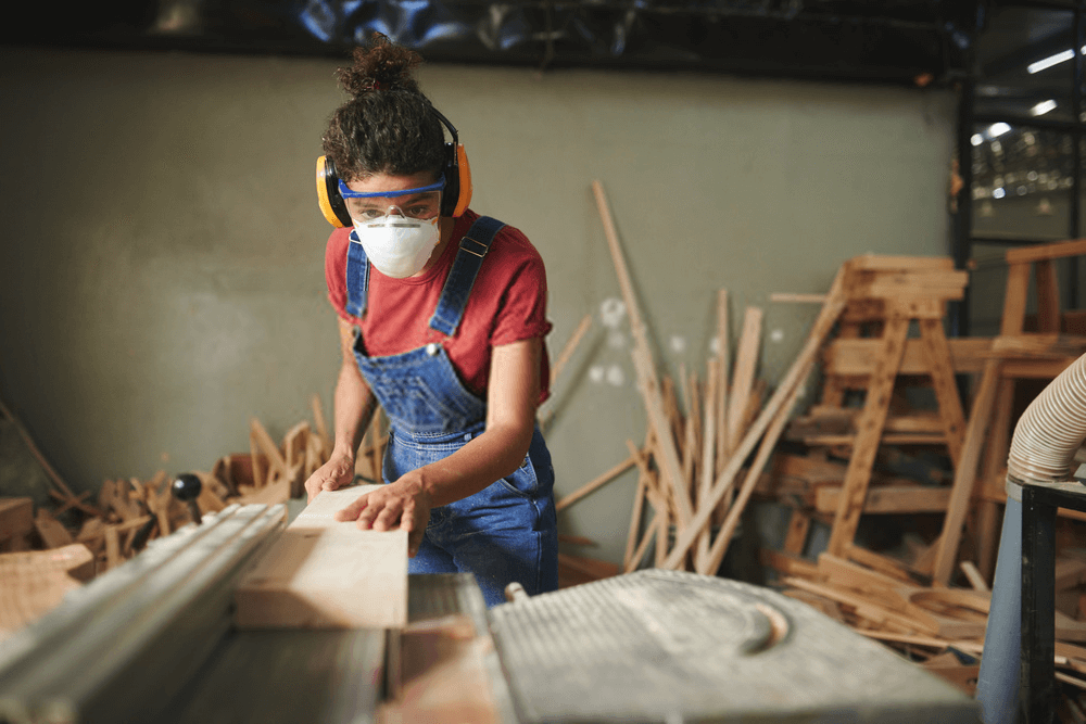 Female working on table saw Female working on table saw