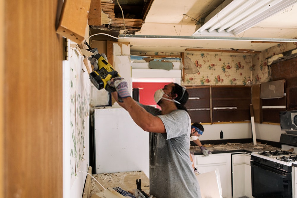 Man Uses Reciprocating Saw Man Uses Reciprocating Saw