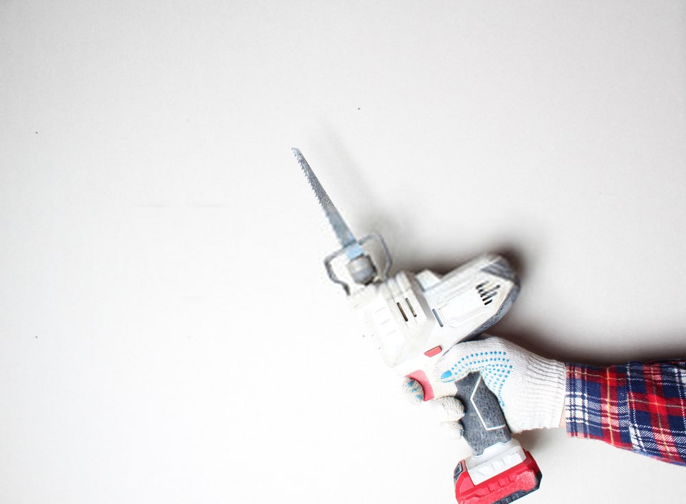 Man holding best reciprocating saw Man holding best reciprocating saw