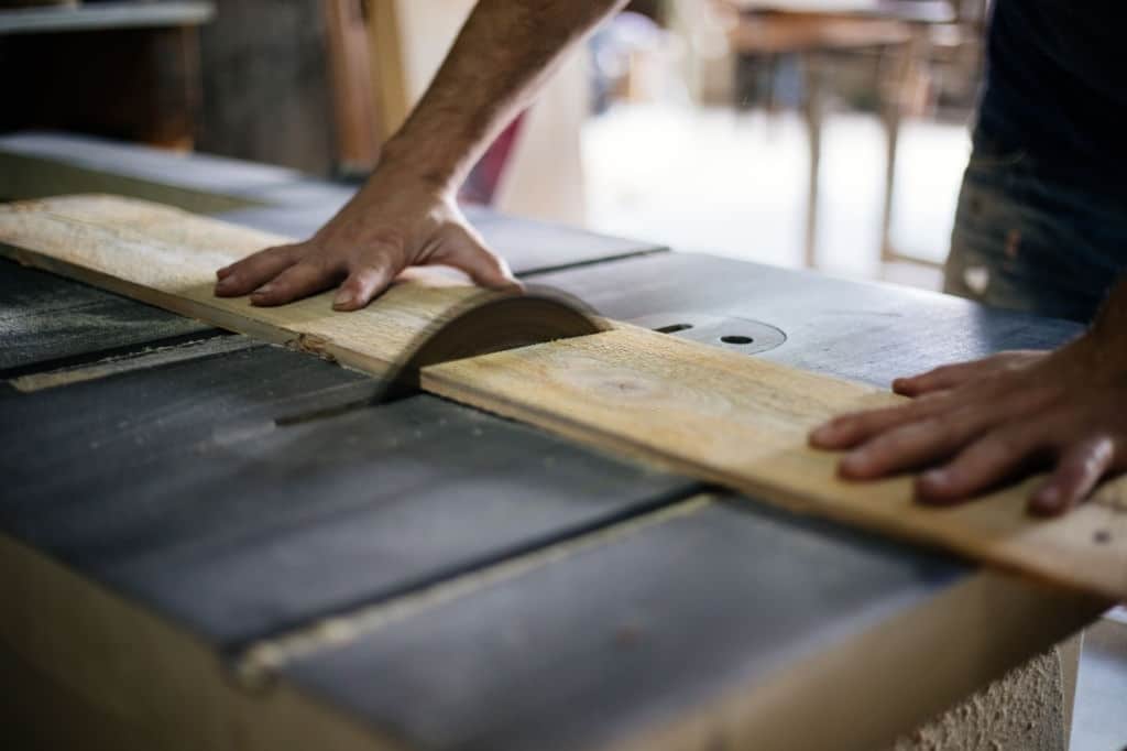 Woodworker cutting wood Woodworker cutting wood With Table Saw