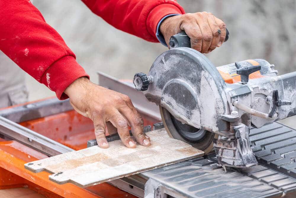 Worker Using Tile Saw to Cut Tile Worker Using Tile Saw to Cut Tile