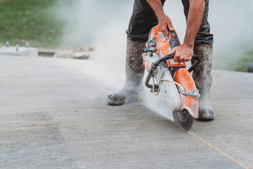 concrete saw Construction worker Cutting concrete using the best concrete saw