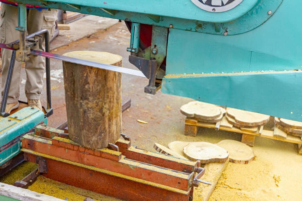 bandsaw-small-log Band saw cutting small log at sawmill