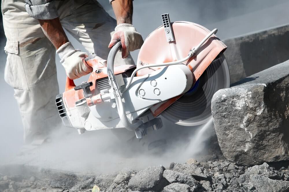 tile-saw-work Worker cutting stone using tile sa